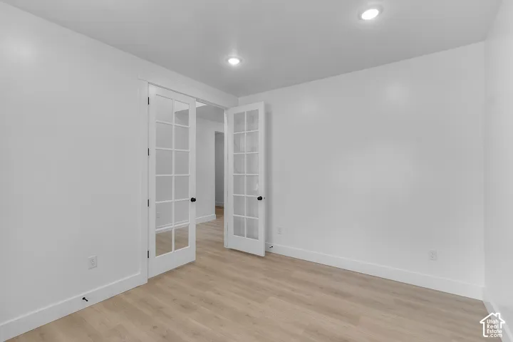 Recessed lighting illuminating the wood-finish flooring