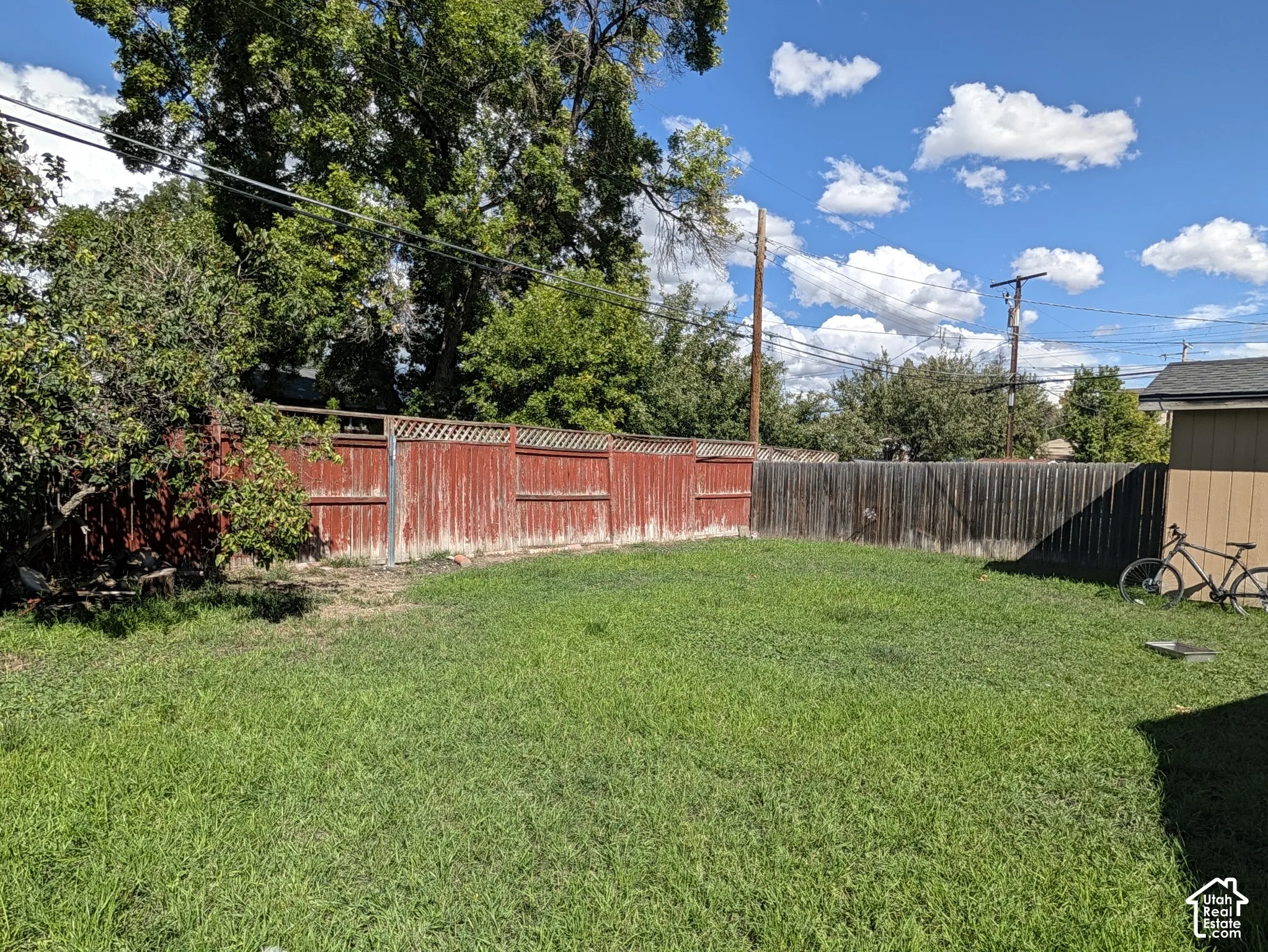 Expansive green lawn with wood perimeter fencing