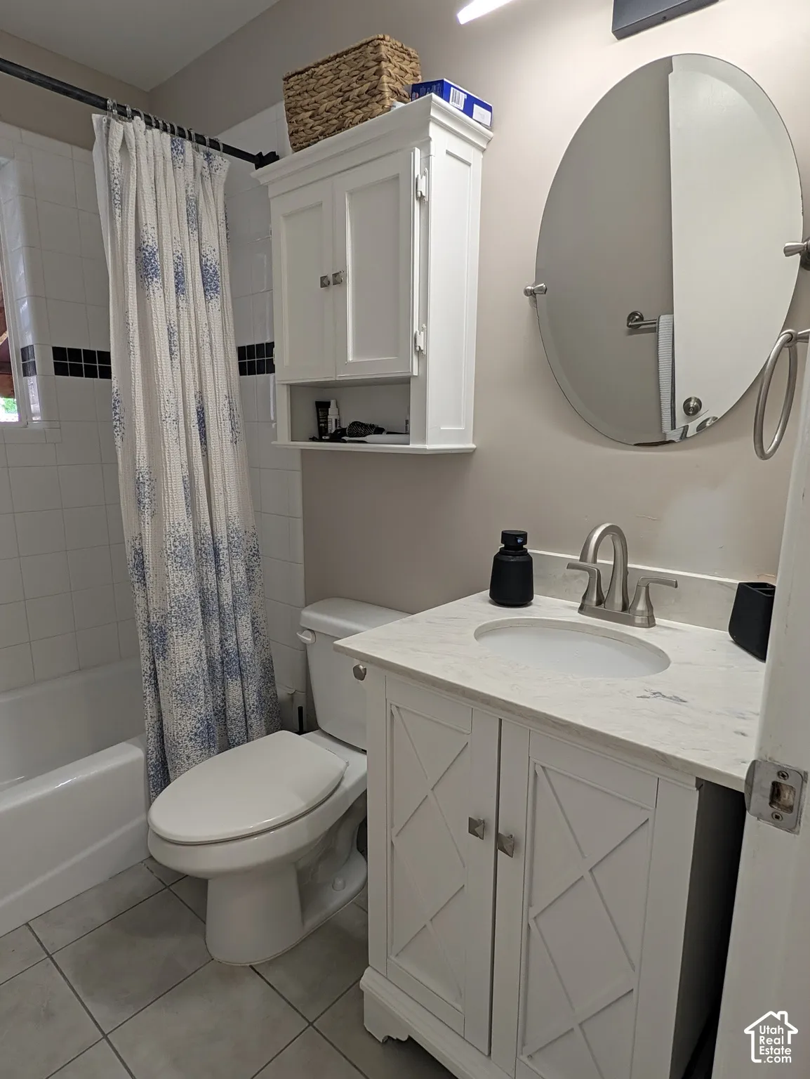 White vanity with an integrated sink and light-colored countertop