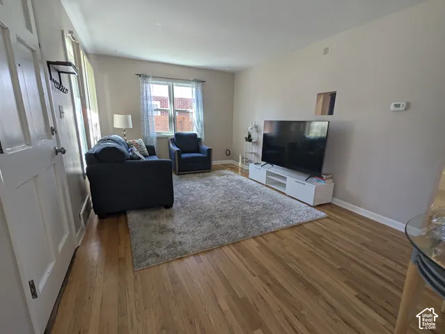 Wood-finish flooring, neutral wall tones, and a window with natural light