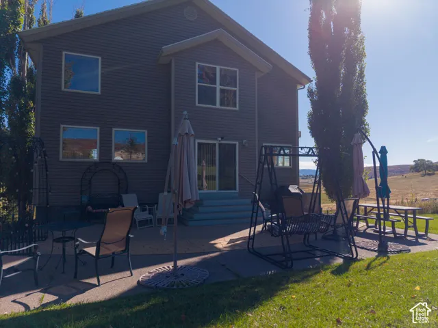 Two-story exterior with horizontal siding, multiple windows, and a sliding glass door
