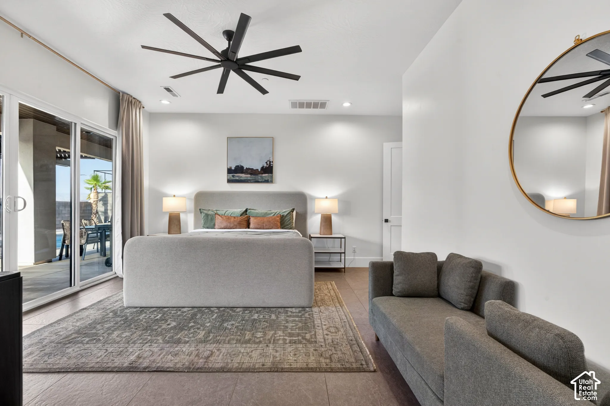 Sliding glass doors, large ceiling fan, recessed lighting, and tile flooring