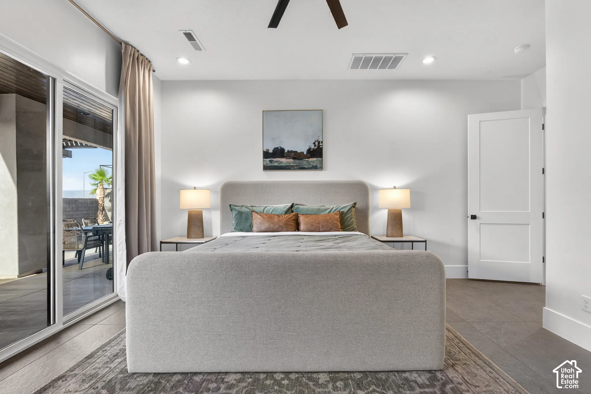 Sliding glass doors, recessed lighting, wood-finish flooring, ceiling fan, and a two-panel interior door