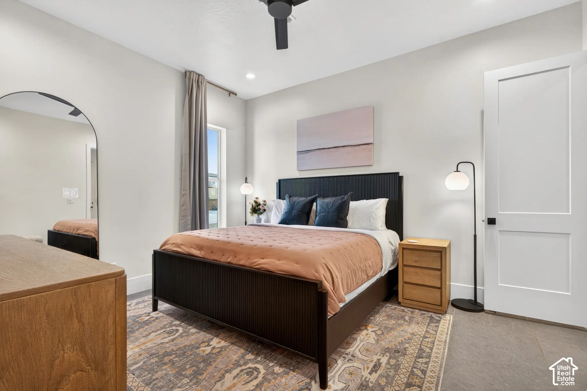 Recessed ceiling lighting, a modern ceiling fan, and a built-in window provide illumination