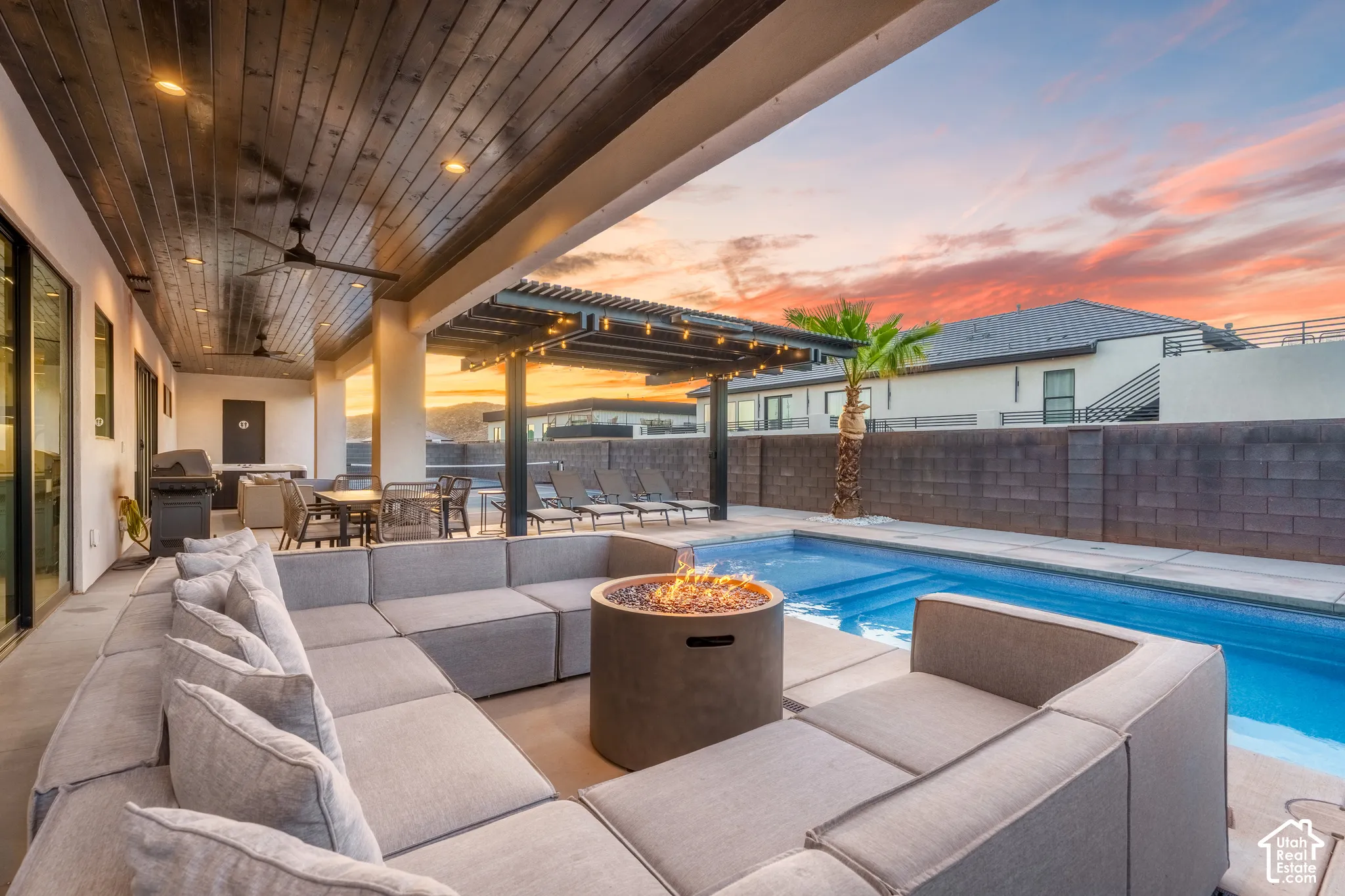 Expansive covered patio with wood-finish ceiling and recessed lighting