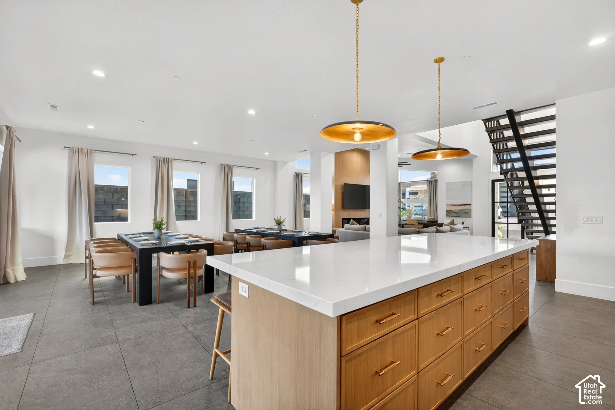 Expansive kitchen island with a white countertop and wood-finish cabinetry