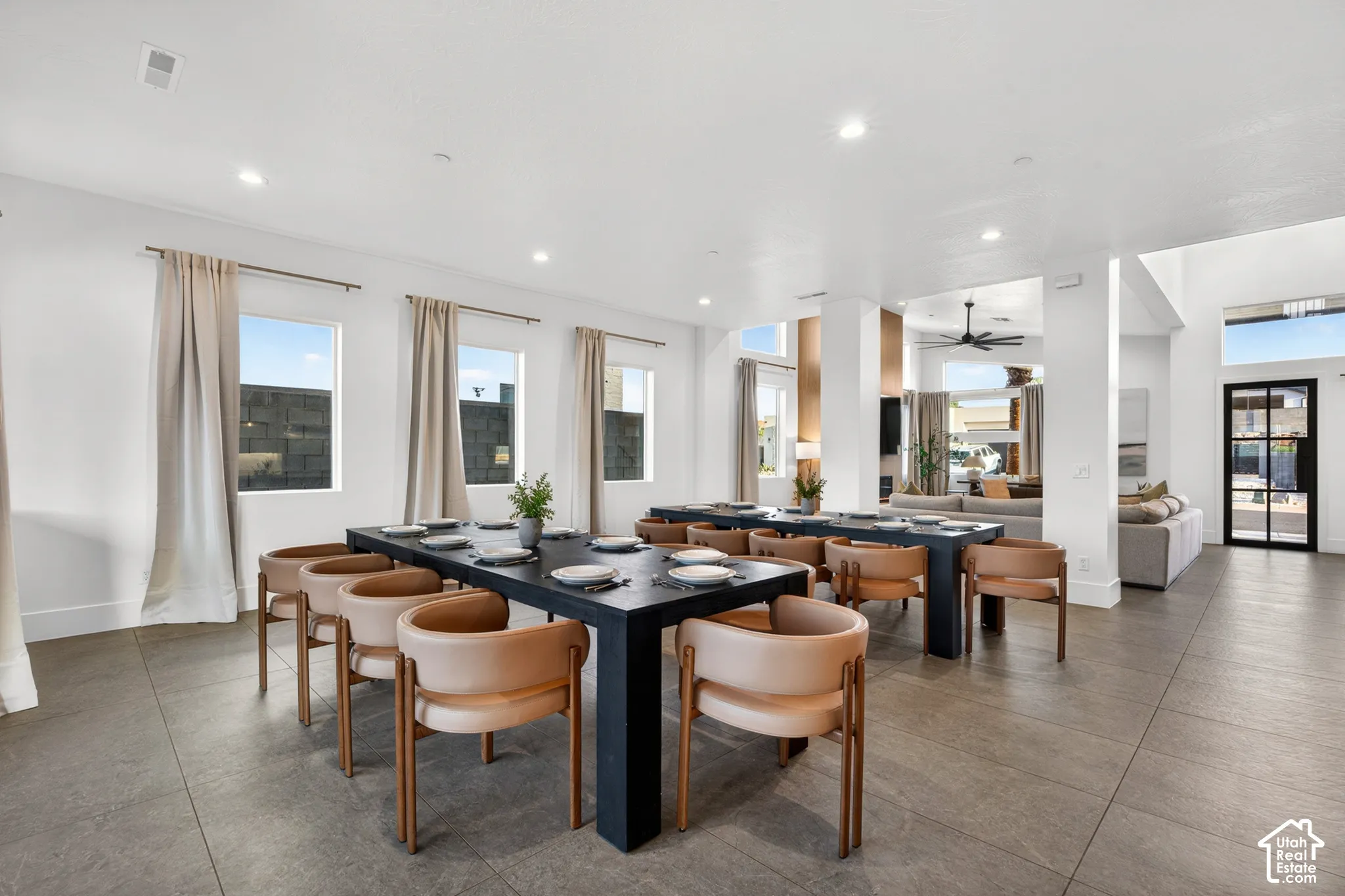 Spacious common area featuring large format tile flooring, recessed lighting, multiple windows, and an open layout