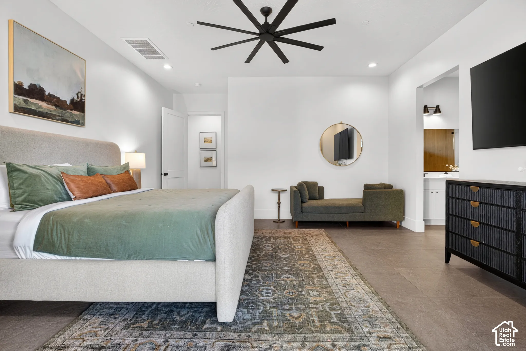 Spacious room featuring high ceilings, recessed lighting, wood-finish flooring, and a modern ceiling fan
