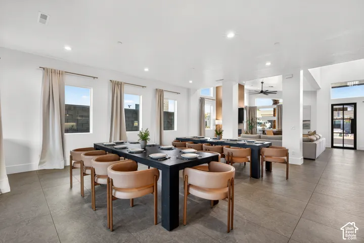 Spacious common area featuring large format tile flooring, recessed lighting, multiple windows, and an open layout