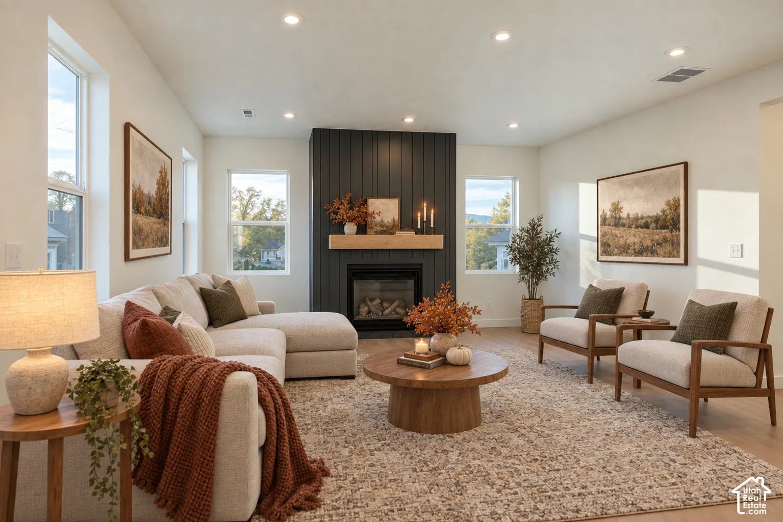 Living area featuring wood-finish flooring, recessed lighting, and multiple windows