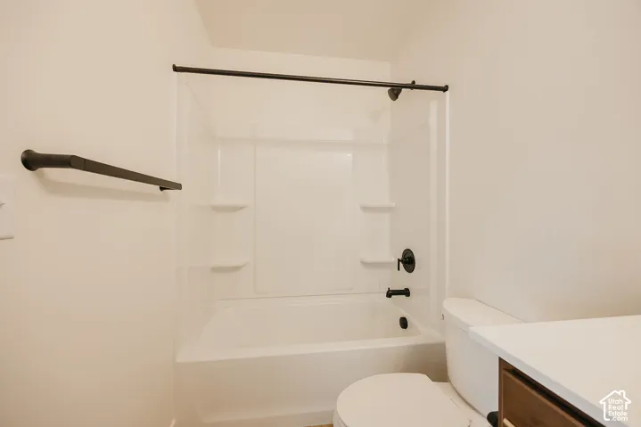 White shower/tub combination with black fixtures and built-in shelving