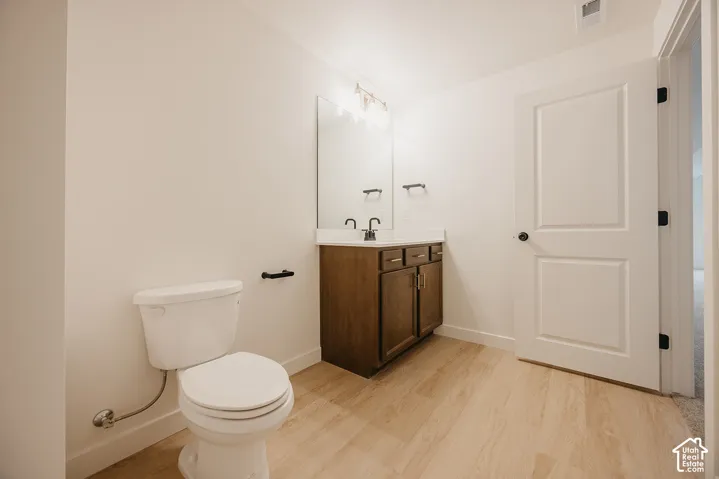Wood-finish flooring, white walls, and a white paneled door