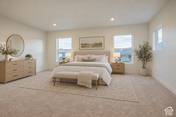 Recessed lighting, multiple windows, broadloom carpeting, and neutral wall tones