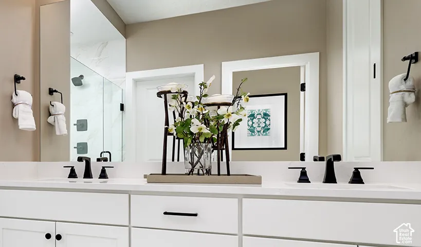 Dual vanity with undermount sinks, white countertops, and matte black plumbing fixtures