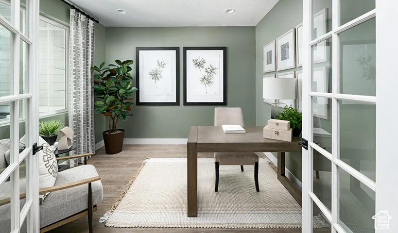 French doors opening into a room with wood-finish flooring, recessed lighting, and a large window