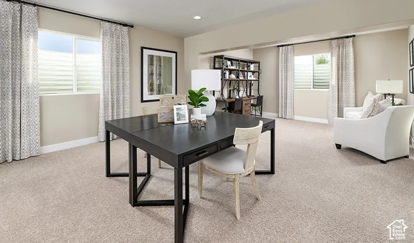 Recessed lighting, light-toned carpeting, and multiple windows with privacy blinds