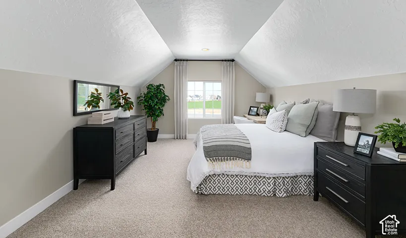 Vaulted ceilings, neutral wall tones, window with natural light, and carpeting