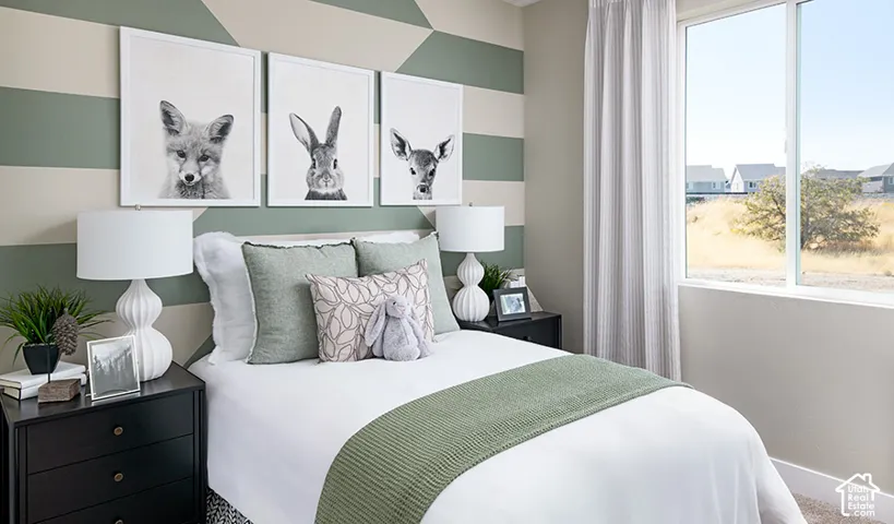 Geometric accent wall, expansive window, durable carpeting, built-in shelving, and contemporary light fixtures