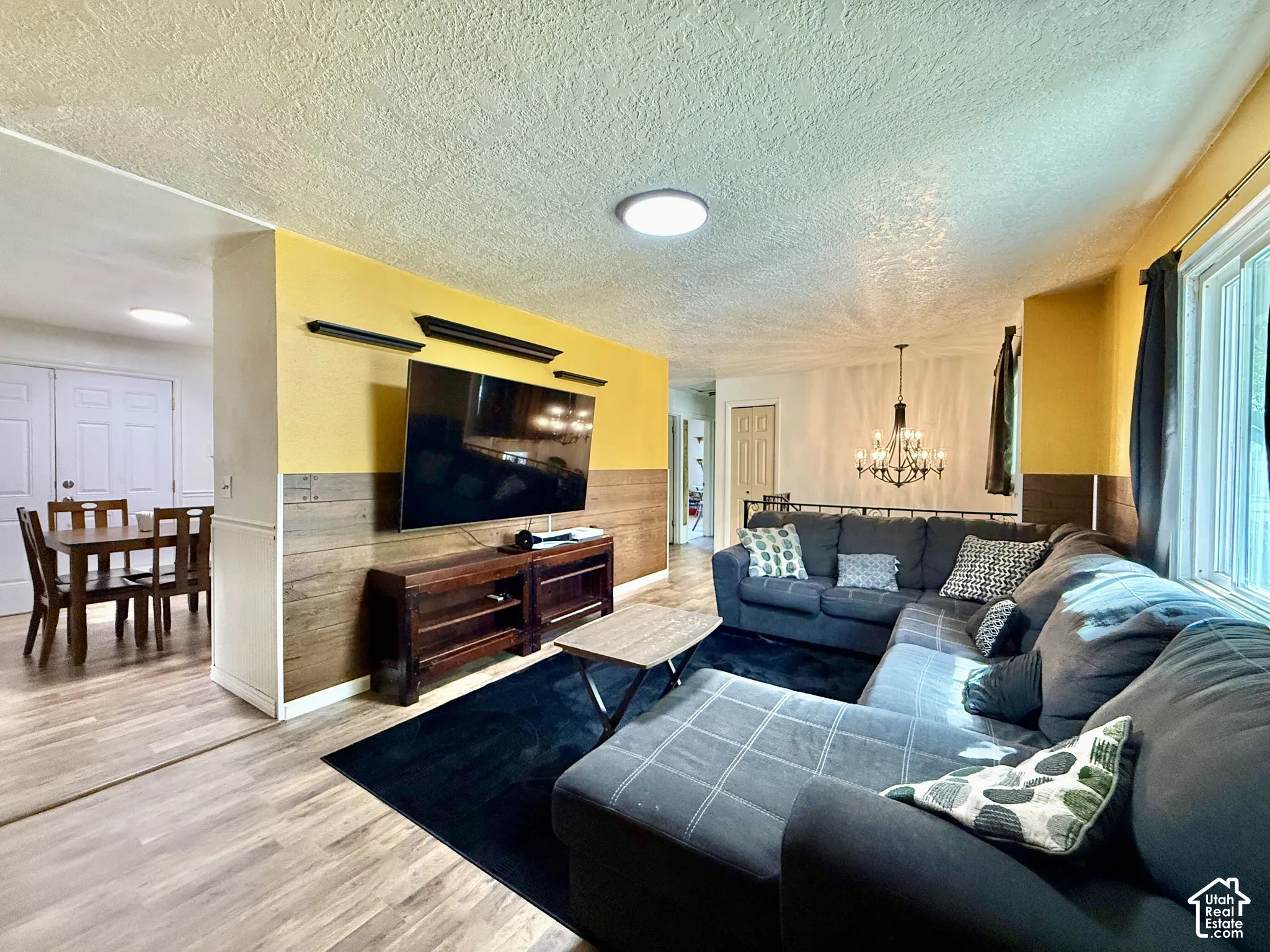 Wood-finish flooring throughout, with a recessed wall feature and paneling