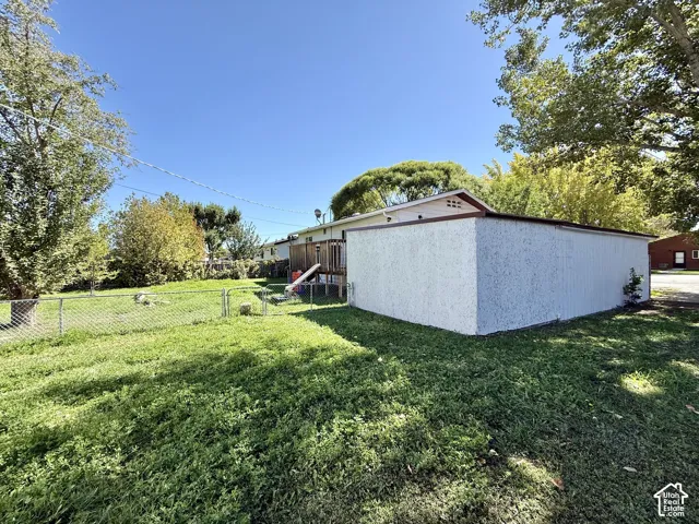 Expansive lawn area with a chain-link fence