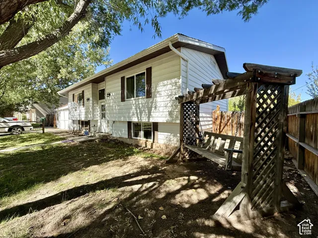White siding exterior with dark window shutters