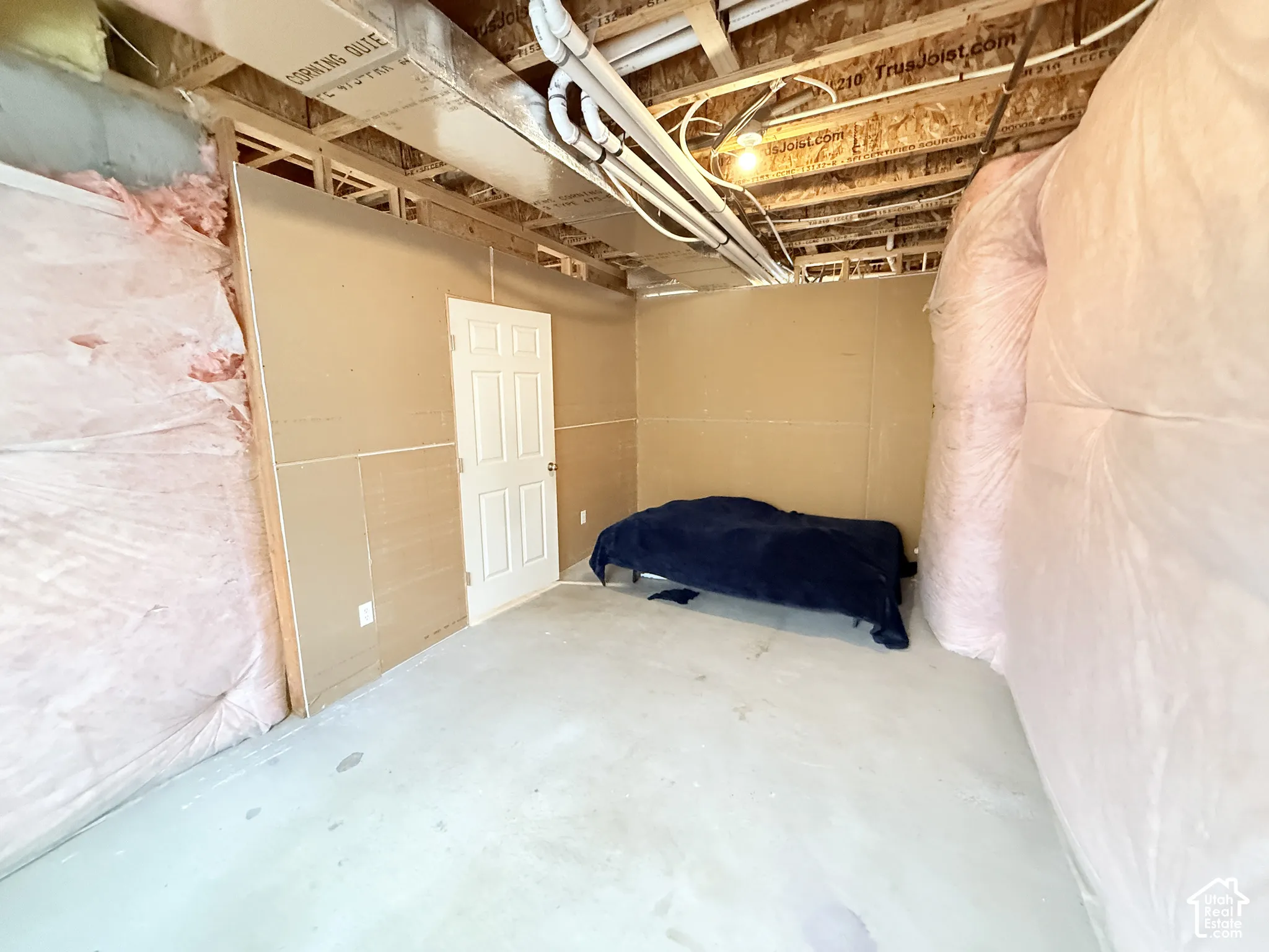 Unfinished interior space with exposed wood framing