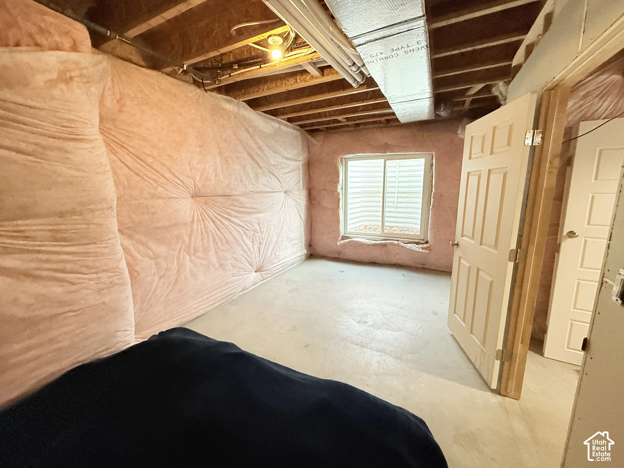 Unfinished interior space with exposed wood framing