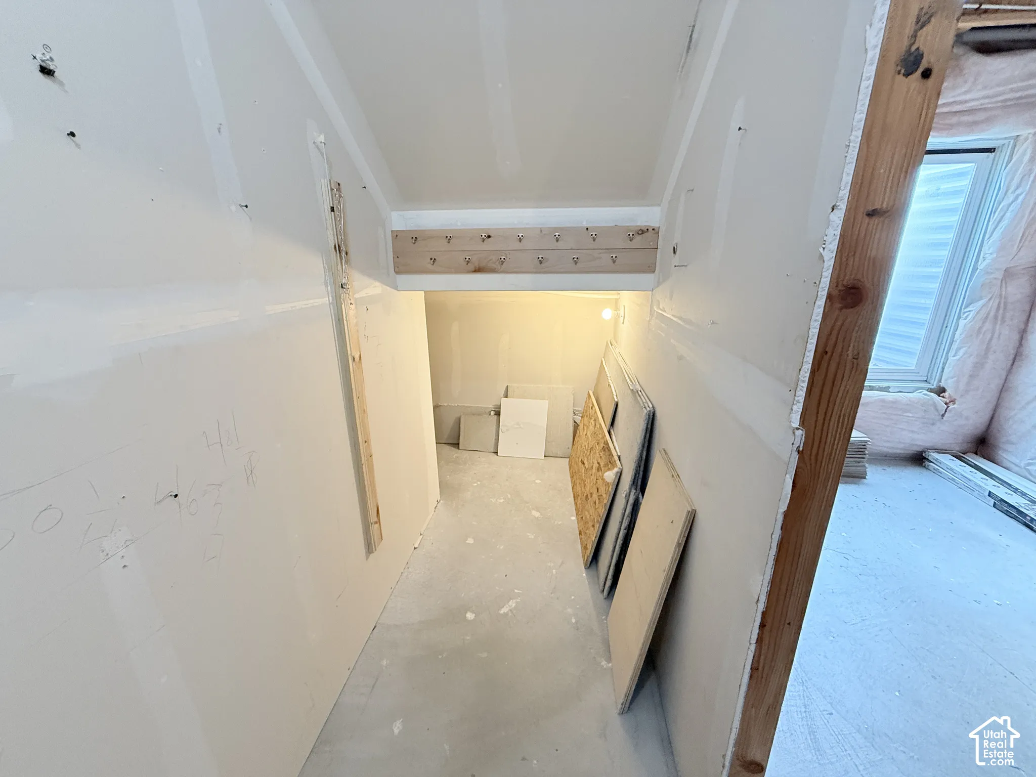 Unfinished interior space with exposed wood framing
