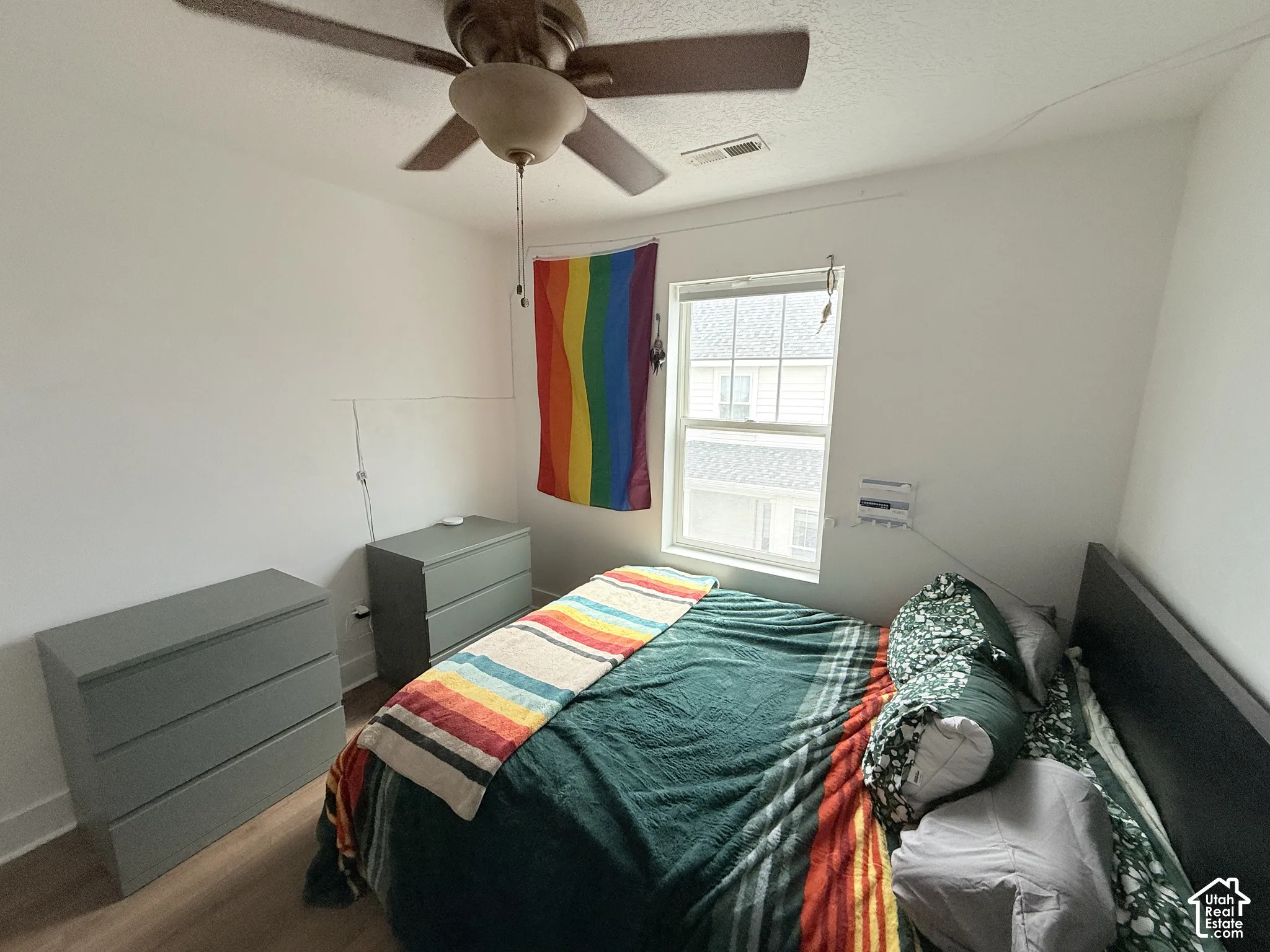 Hard-surface flooring, white walls, and a ceiling fan with light fixture