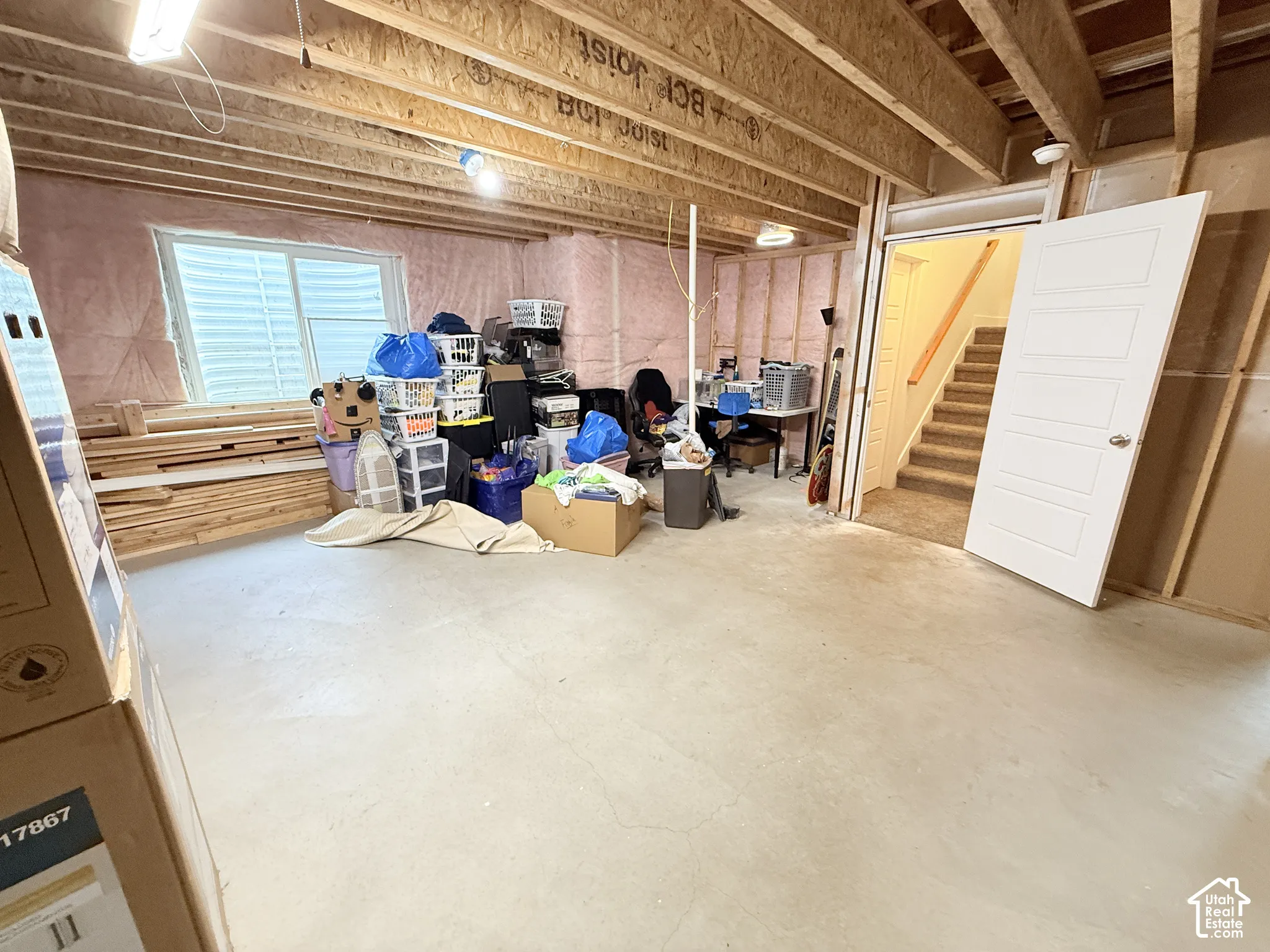 Unfinished interior space with exposed wood framing