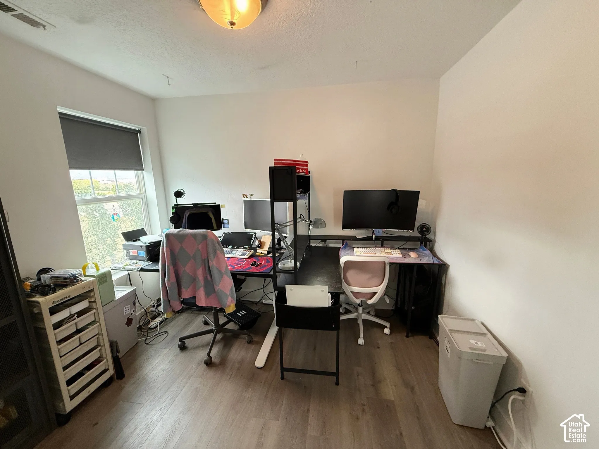 Recessed lighting, wood-finish flooring, and white walls