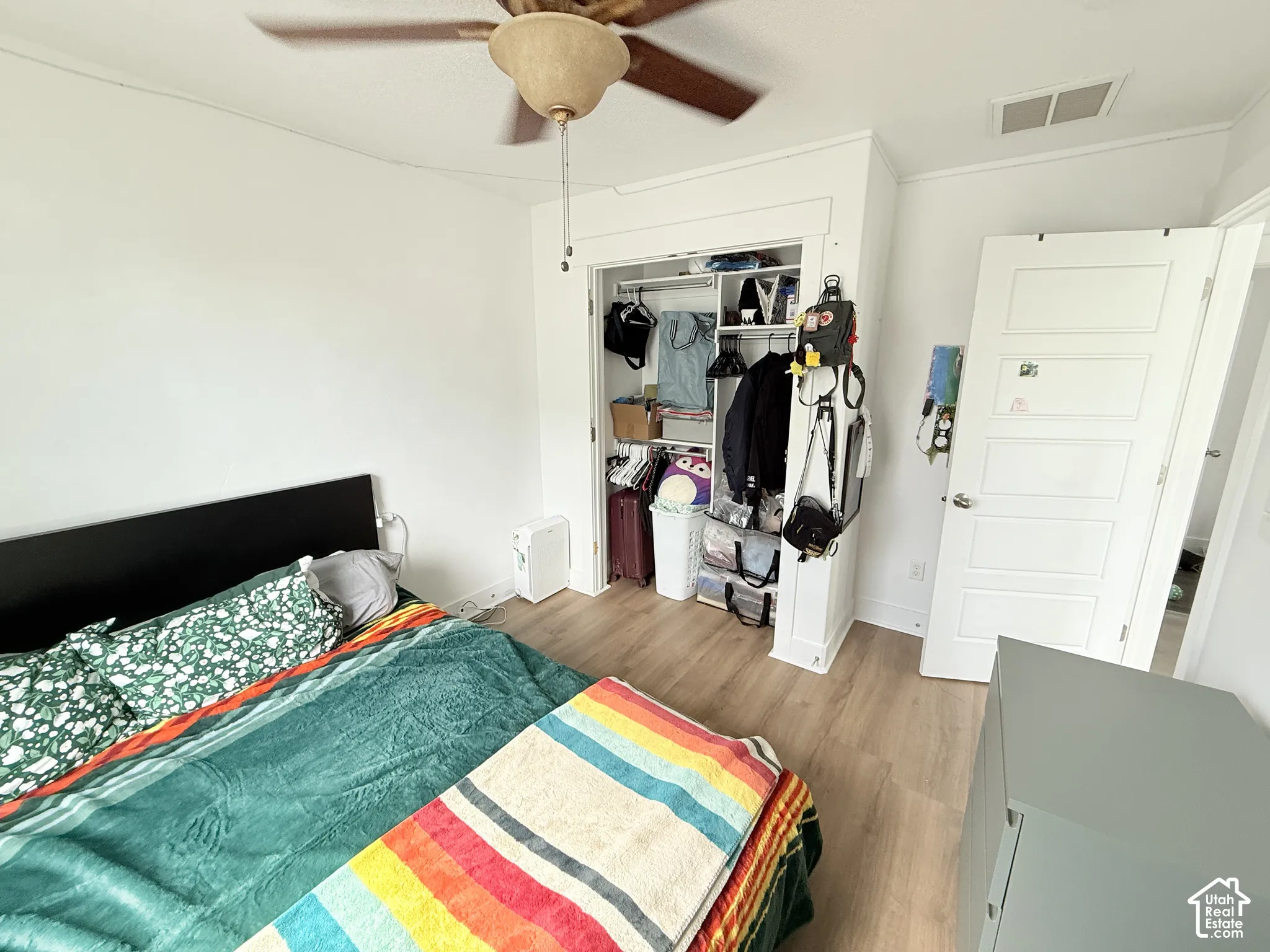 Wood-finish flooring, ceiling fan, and built-in closet