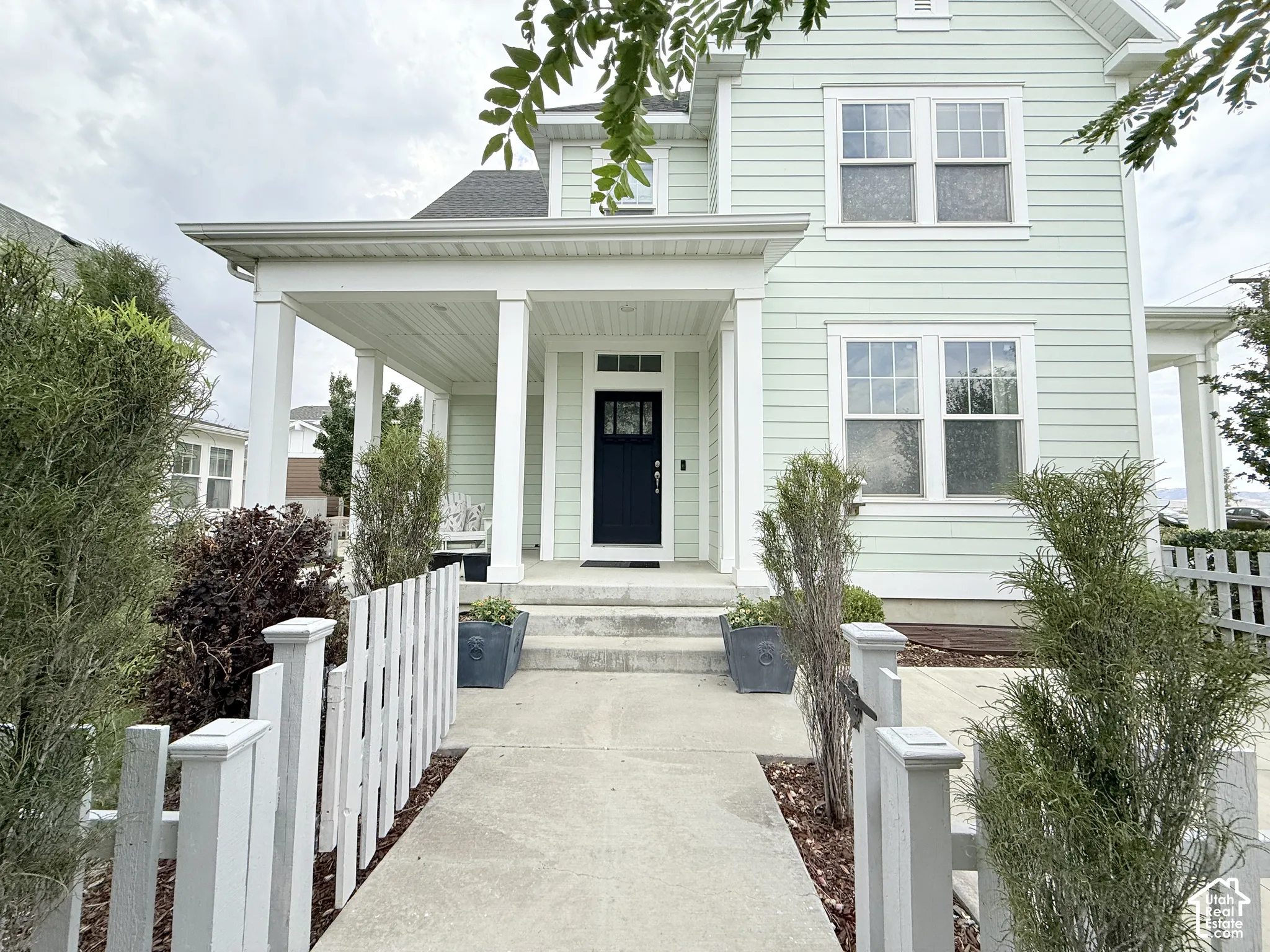 Light green horizontal siding exterior with white trim