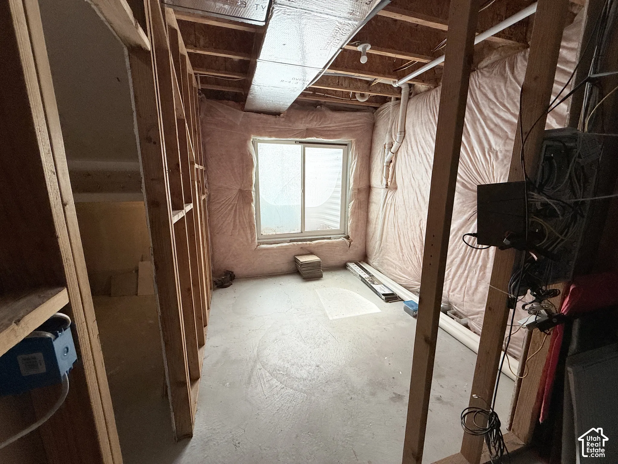 Unfinished interior space with exposed wood framing