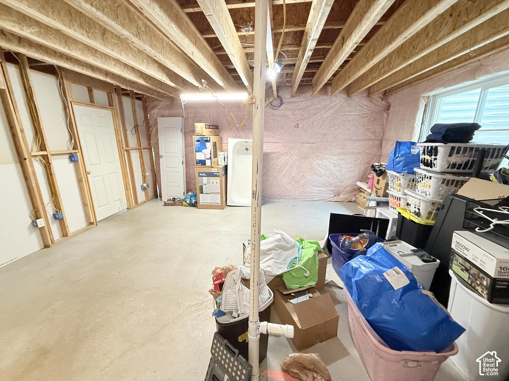 Unfinished interior space with exposed wood framing