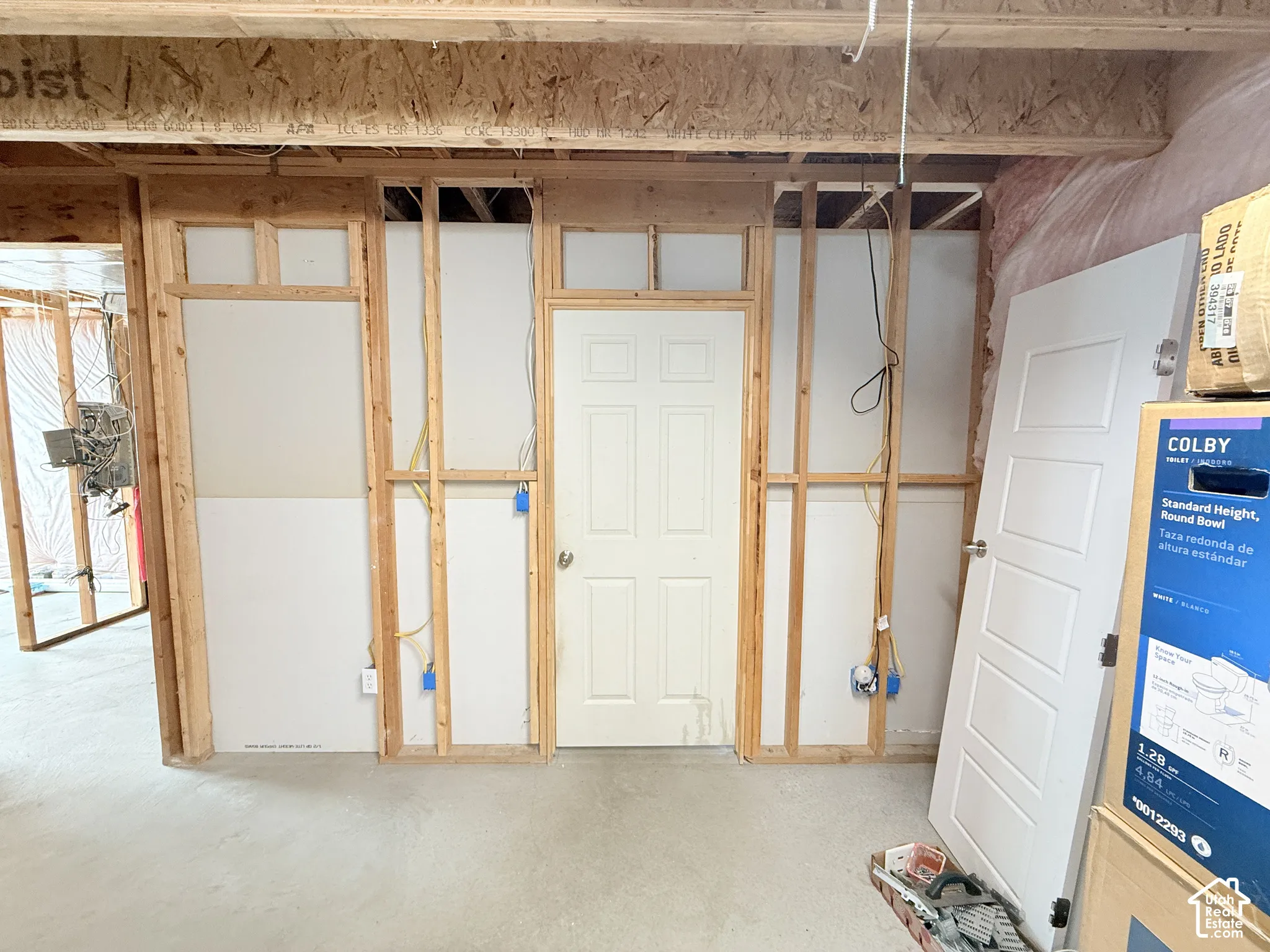 Unfinished interior space with exposed wood framing