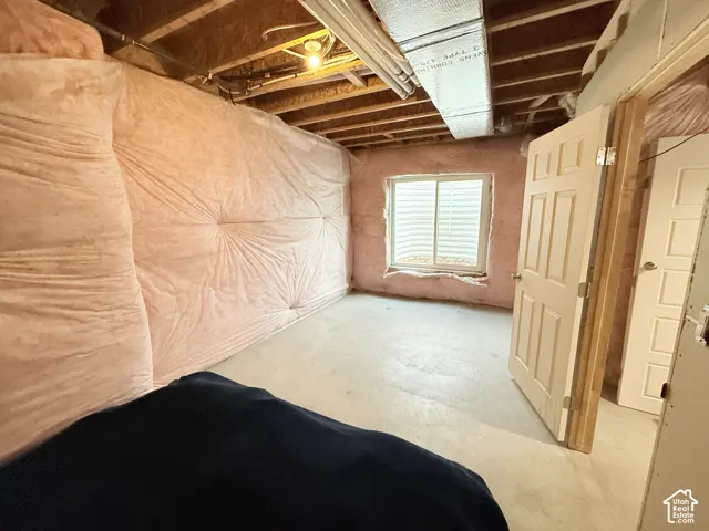 Unfinished interior space with exposed wood framing