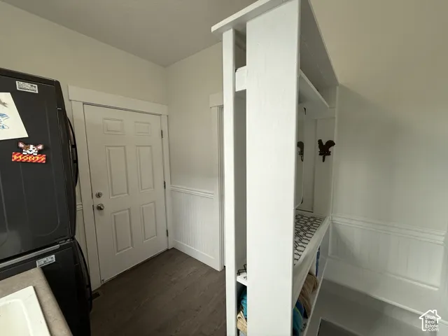 Built-in shelving unit, beadboard wainscoting, wood-finish flooring, white paneled door