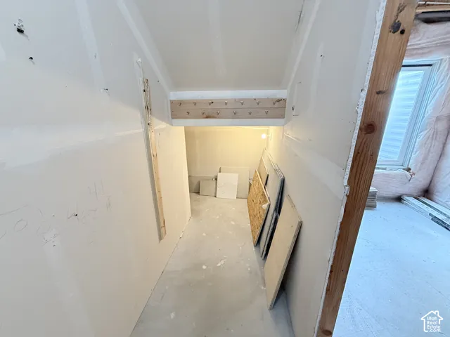 Unfinished interior space with exposed wood framing