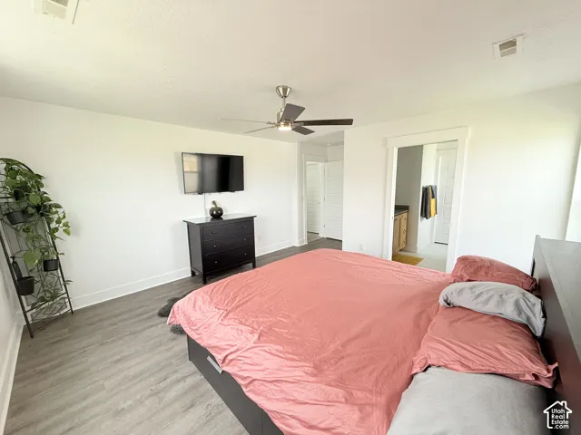 Recessed lighting, wood-finish flooring, ceiling fan, and white trim
