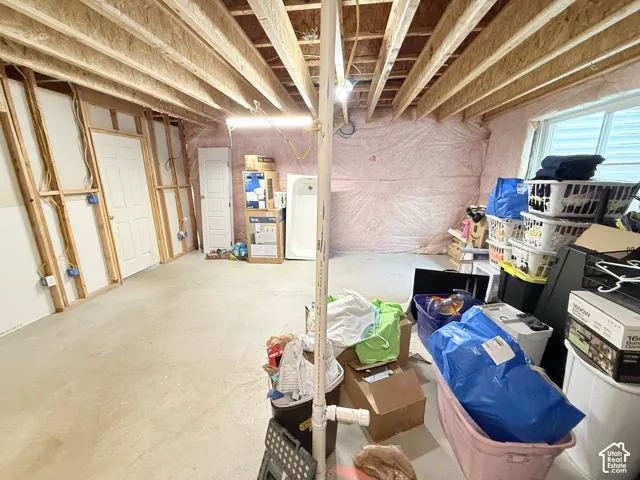 Unfinished interior space with exposed wood framing