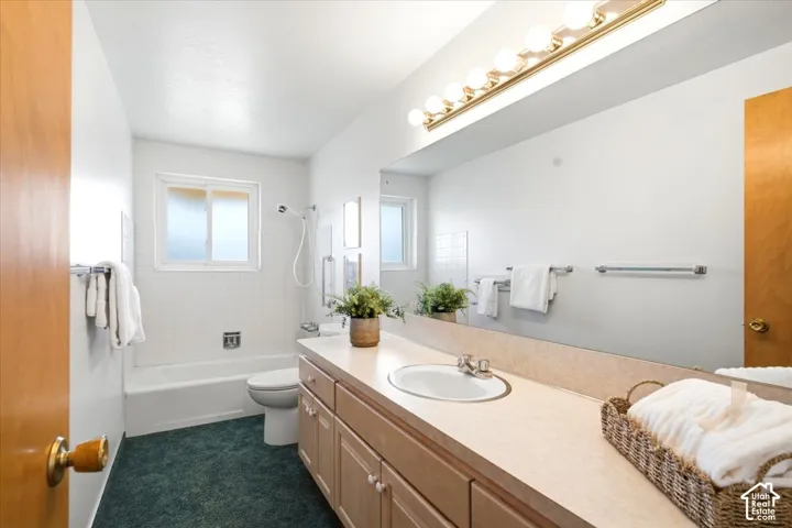 Full-length vanity mirror with a light wood-finish cabinet and built-in sink