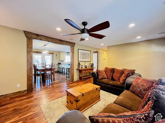 Wood-finish flooring throughout, recessed lighting, and a ceiling fan