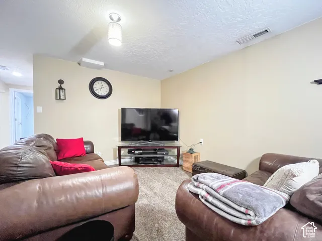 Recessed lighting and ceiling-mounted fixture illuminate the space