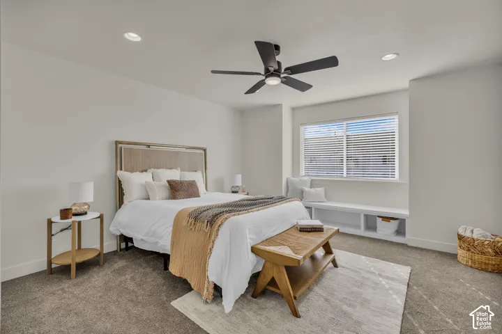 Recessed lighting, ceiling fan with integrated lighting, window with blinds, built-in window bench, and carpeted flooring