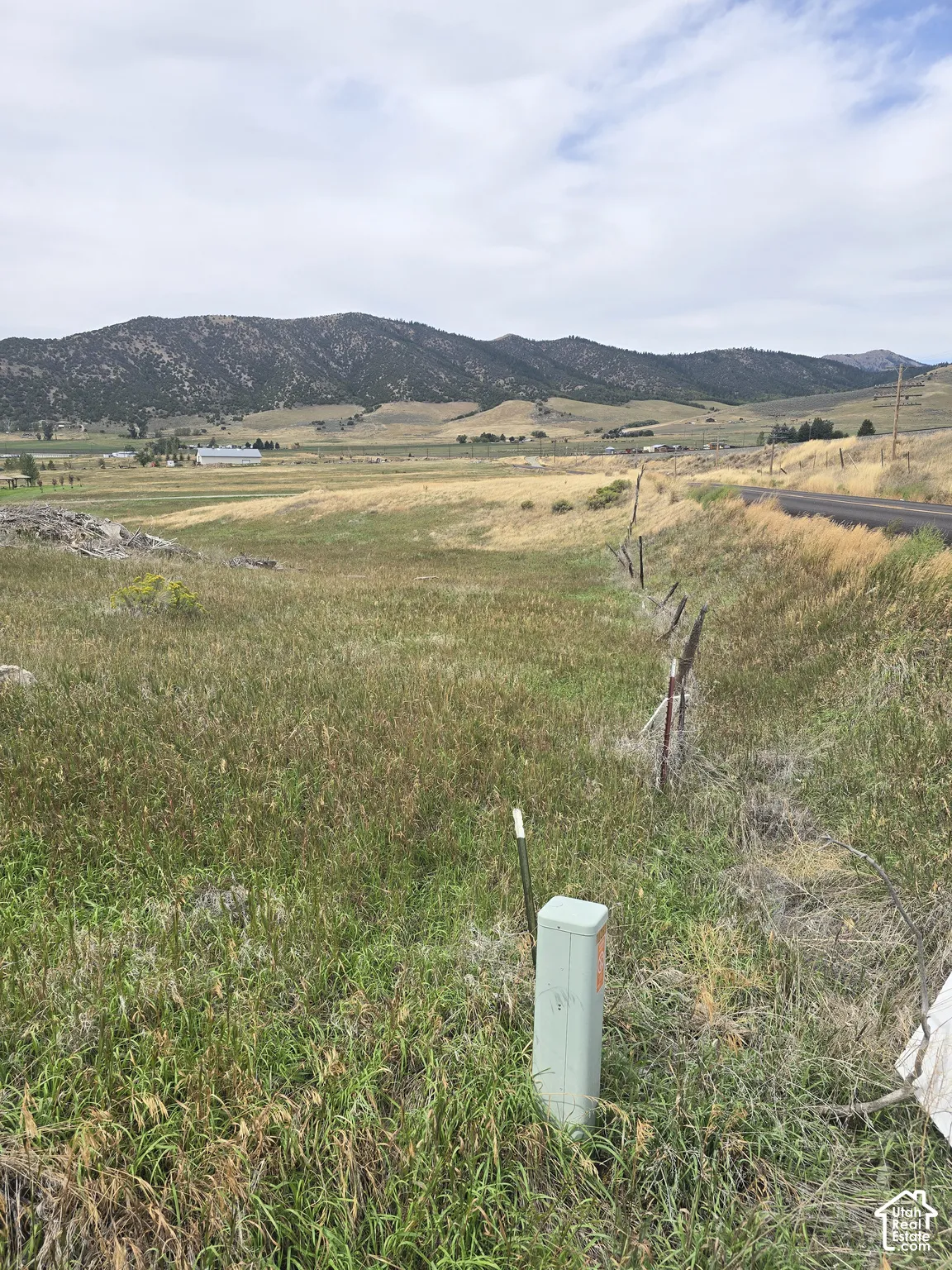 Expansive lot with natural grasses and distant mountain formations