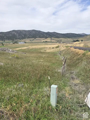 Expansive lot with natural grasses and distant mountain formations