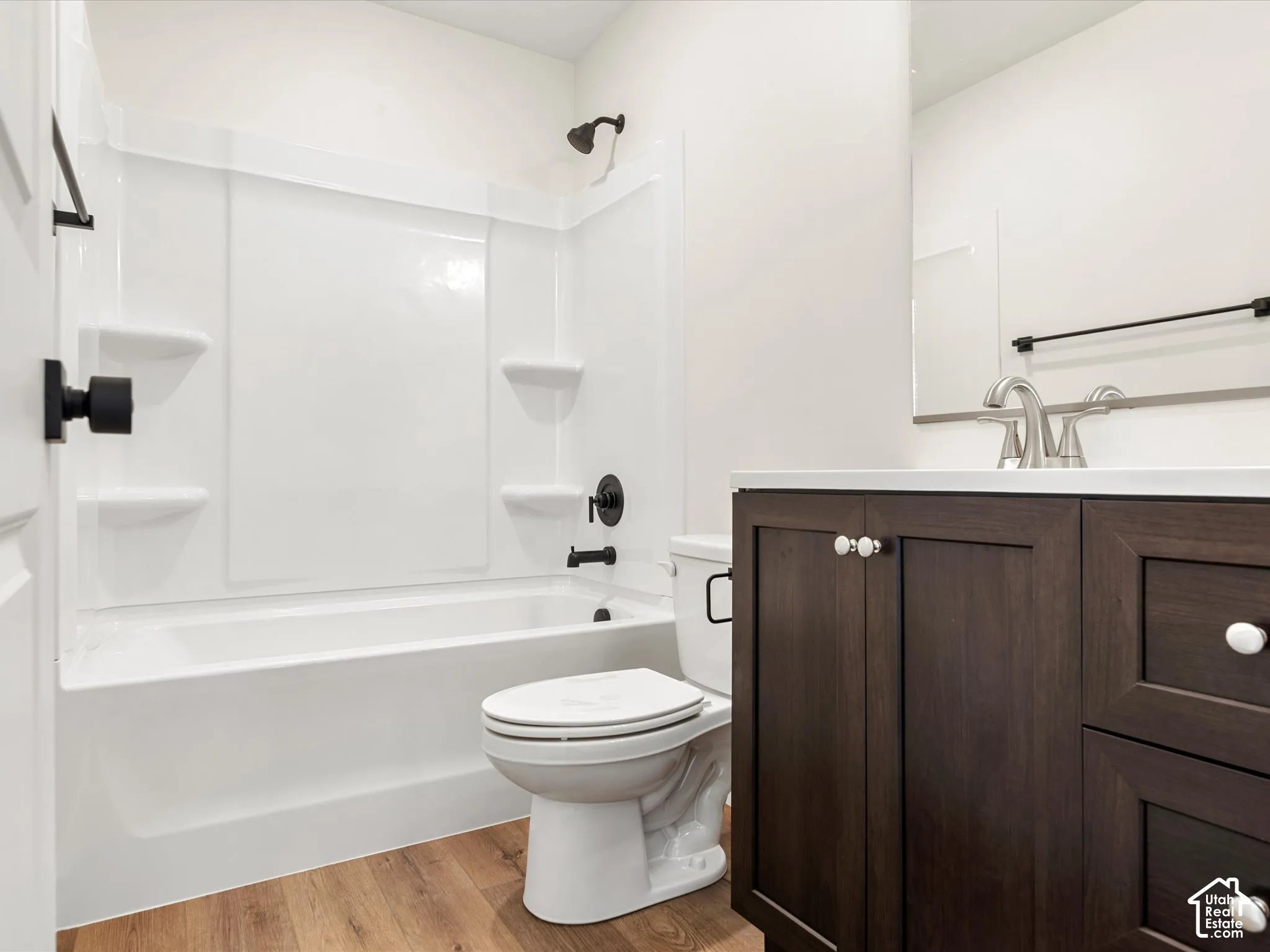 White shower-tub combination with matte black fixtures