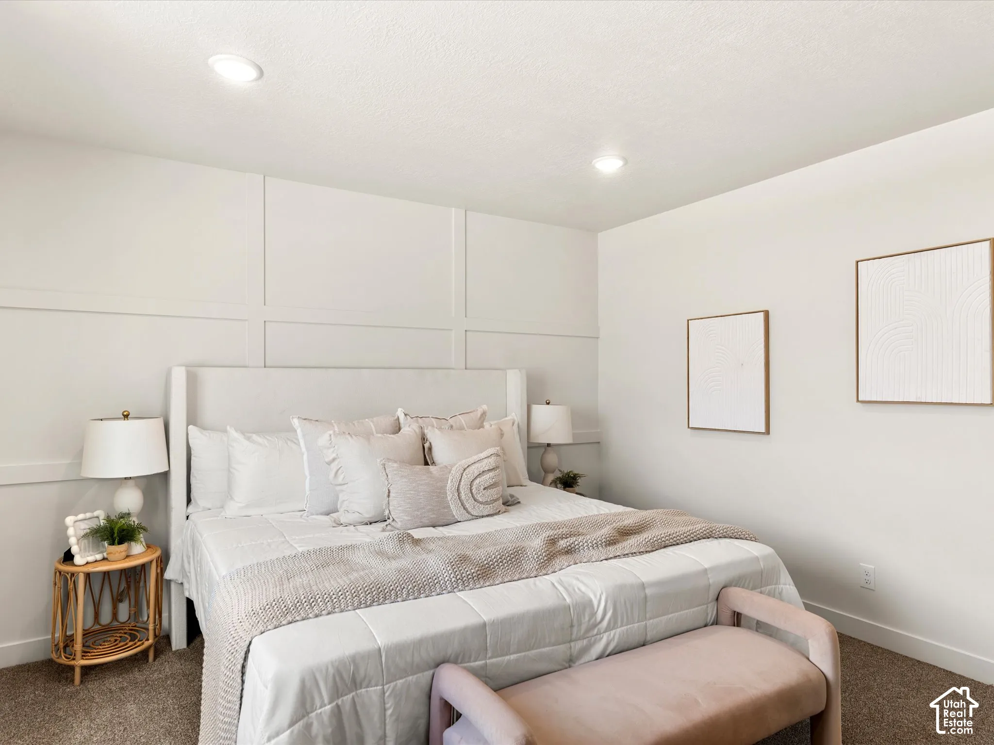 Recessed ceiling lighting, textured wall paneling, and carpeted flooring