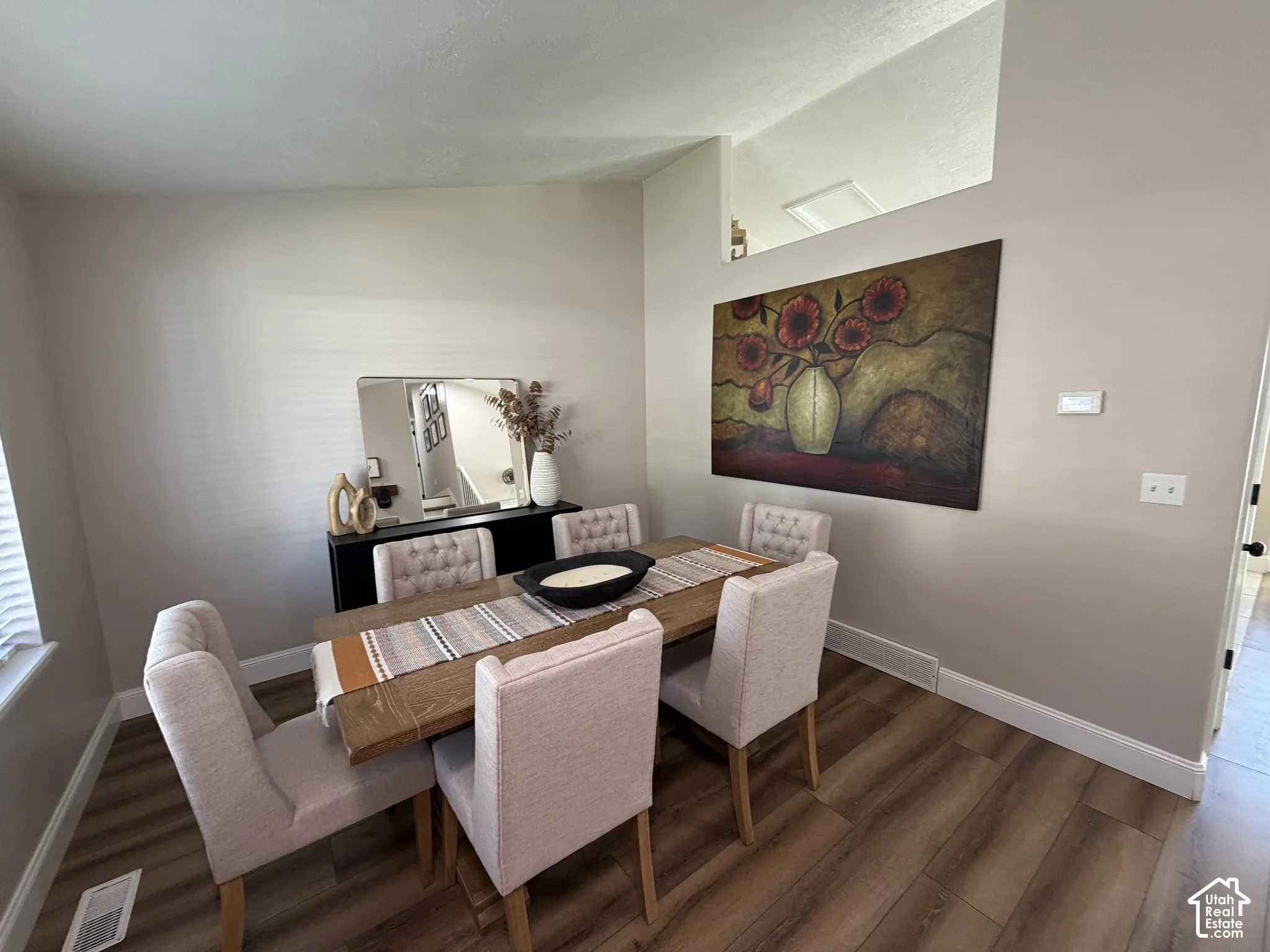 Wood-finish flooring, neutral wall tones, and white trim